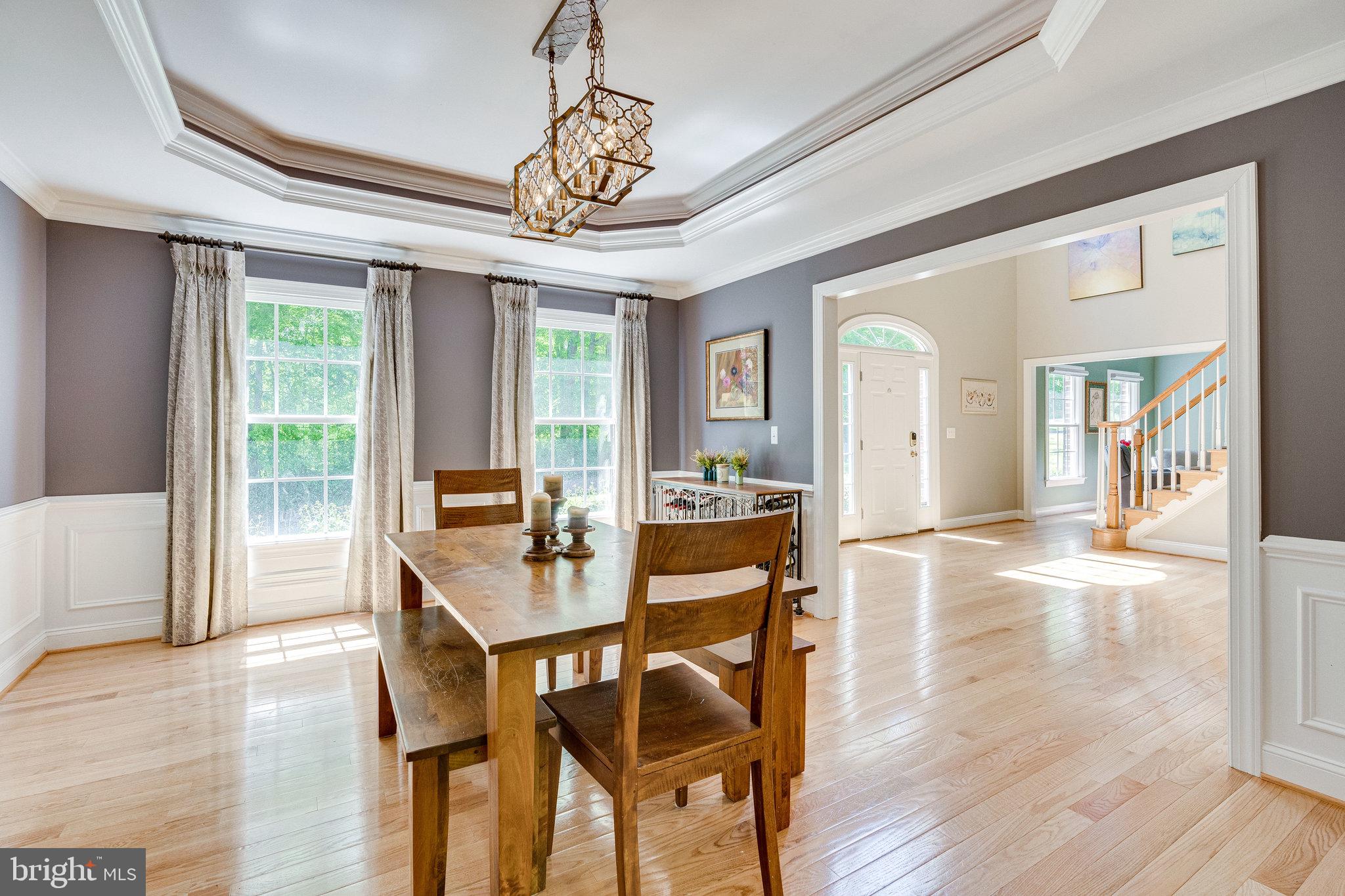 7802 Creekside View Lane Springfield, VA 22153 - Photo 14 of 107 a view of a dining room with furniture wooden floor and chandelier