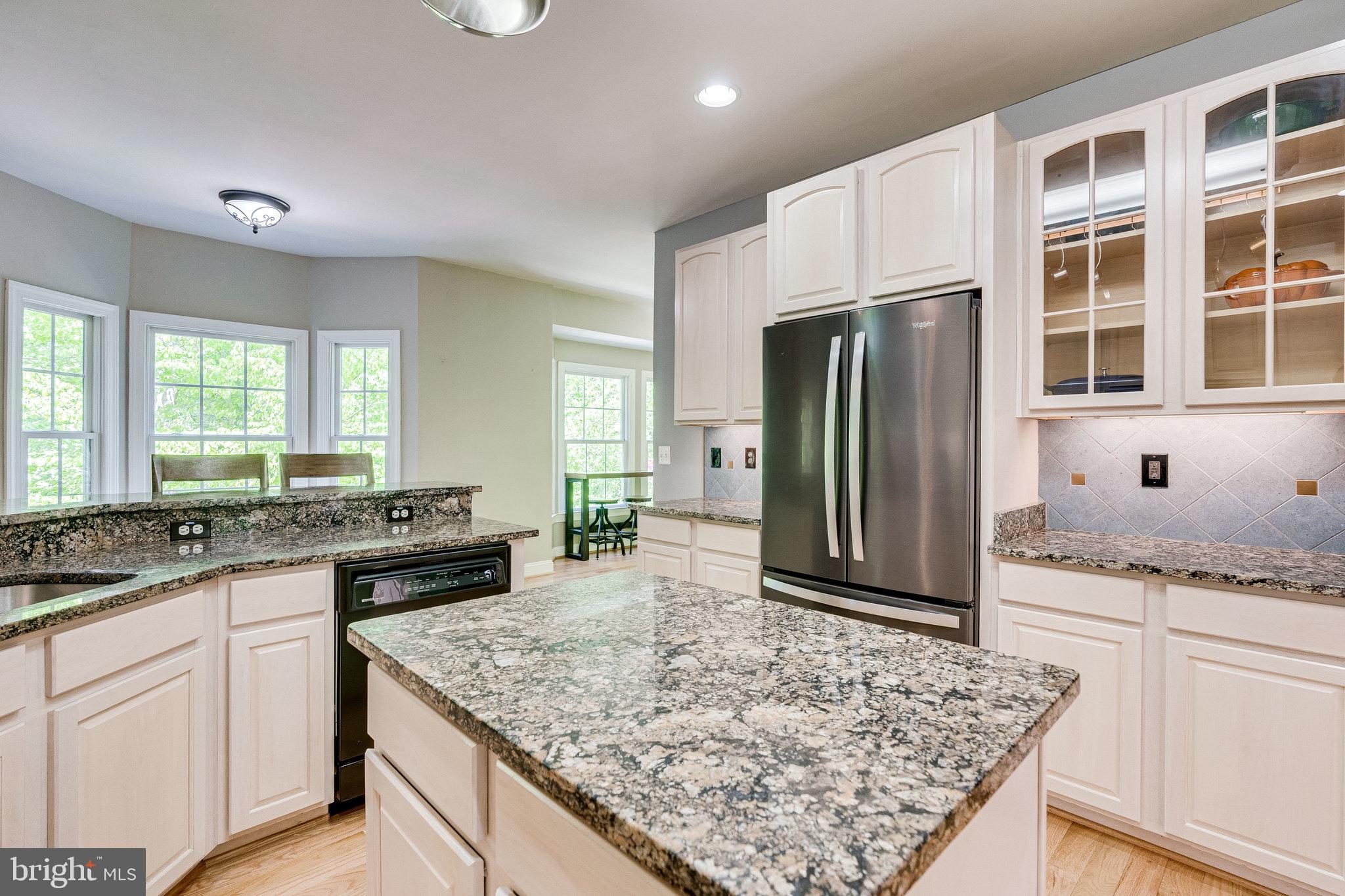 7802 Creekside View Lane Springfield, VA 22153 - Photo 17 of 107 a kitchen with stainless steel appliances granite countertop granite counter tops and white cabinets