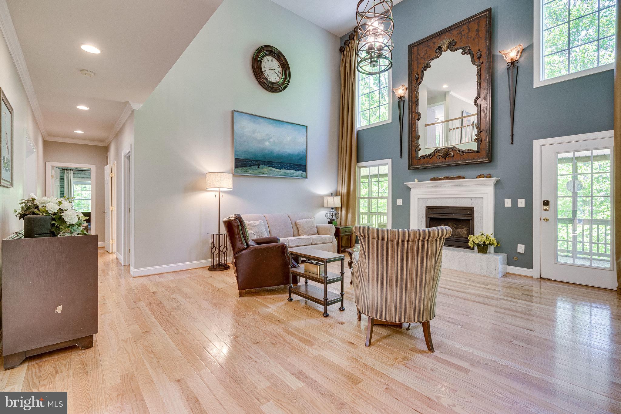 7802 Creekside View Lane Springfield, VA 22153 - Photo 31 of 107 a living room with furniture a fireplace and a flat screen tv