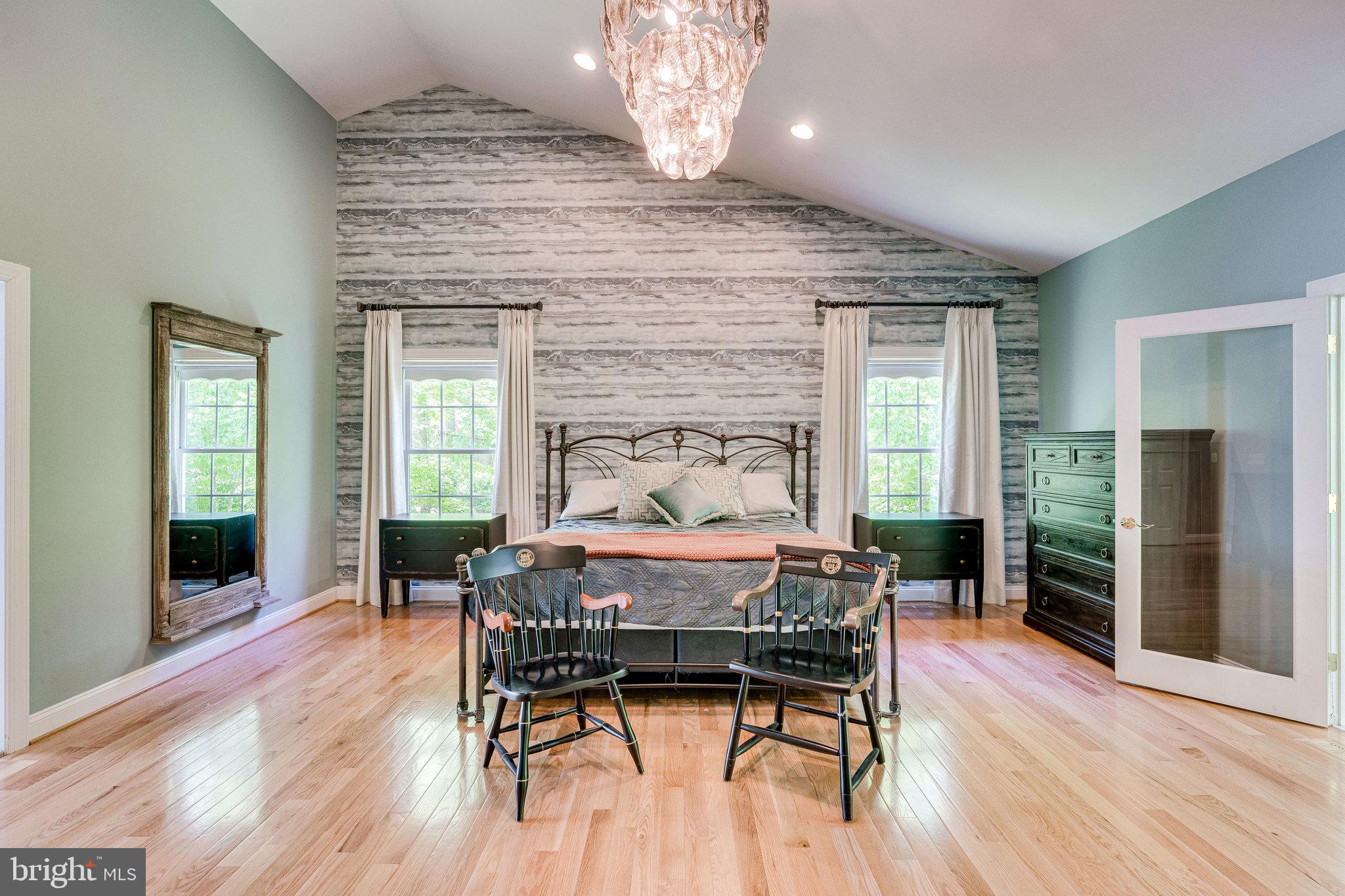 7802 Creekside View Lane Springfield, VA 22153 - Photo 38 of 107 a dining room with furniture a chandelier and wooden floor