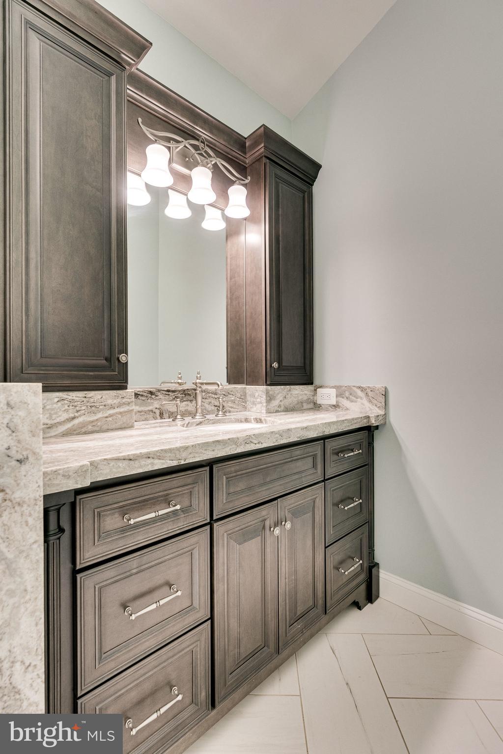 7802 Creekside View Lane Springfield, VA 22153 - Photo 50 of 107 a bathroom with a granite countertop sink double vanity and a mirror