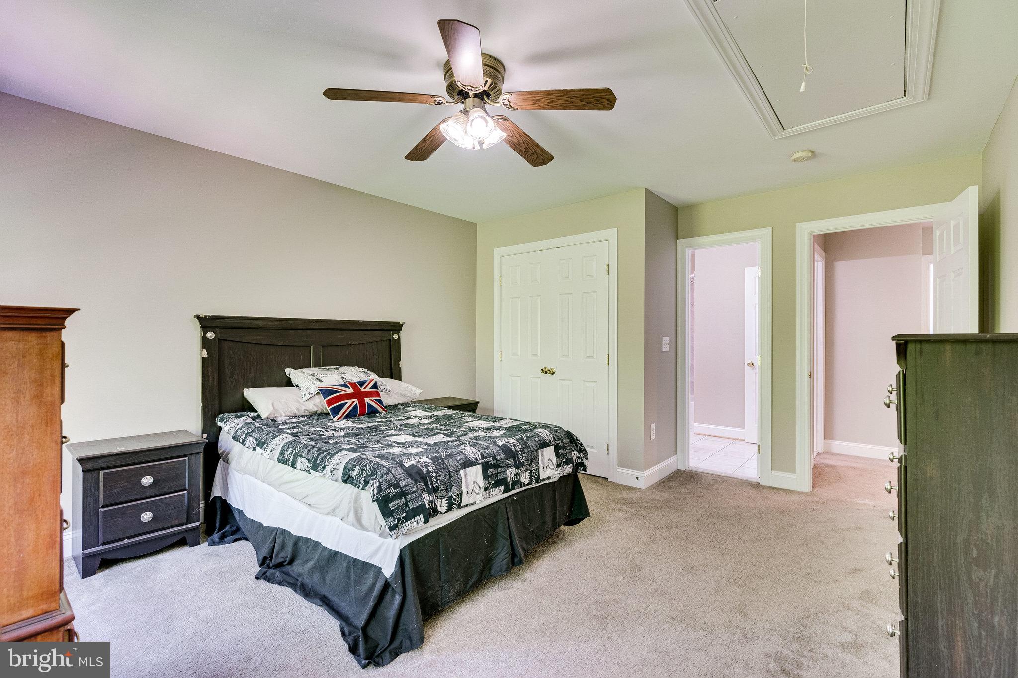 7802 Creekside View Lane Springfield, VA 22153 - Photo 65 of 107 a bedroom with a bed and a chandelier