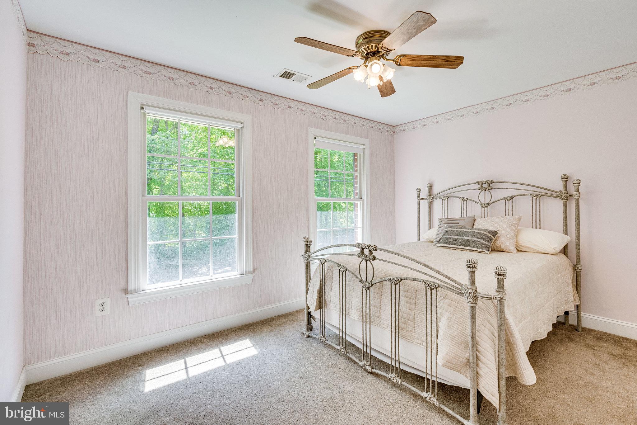 7802 Creekside View Lane Springfield, VA 22153 - Photo 71 of 107 a bedroom with a bed and a ceiling fan