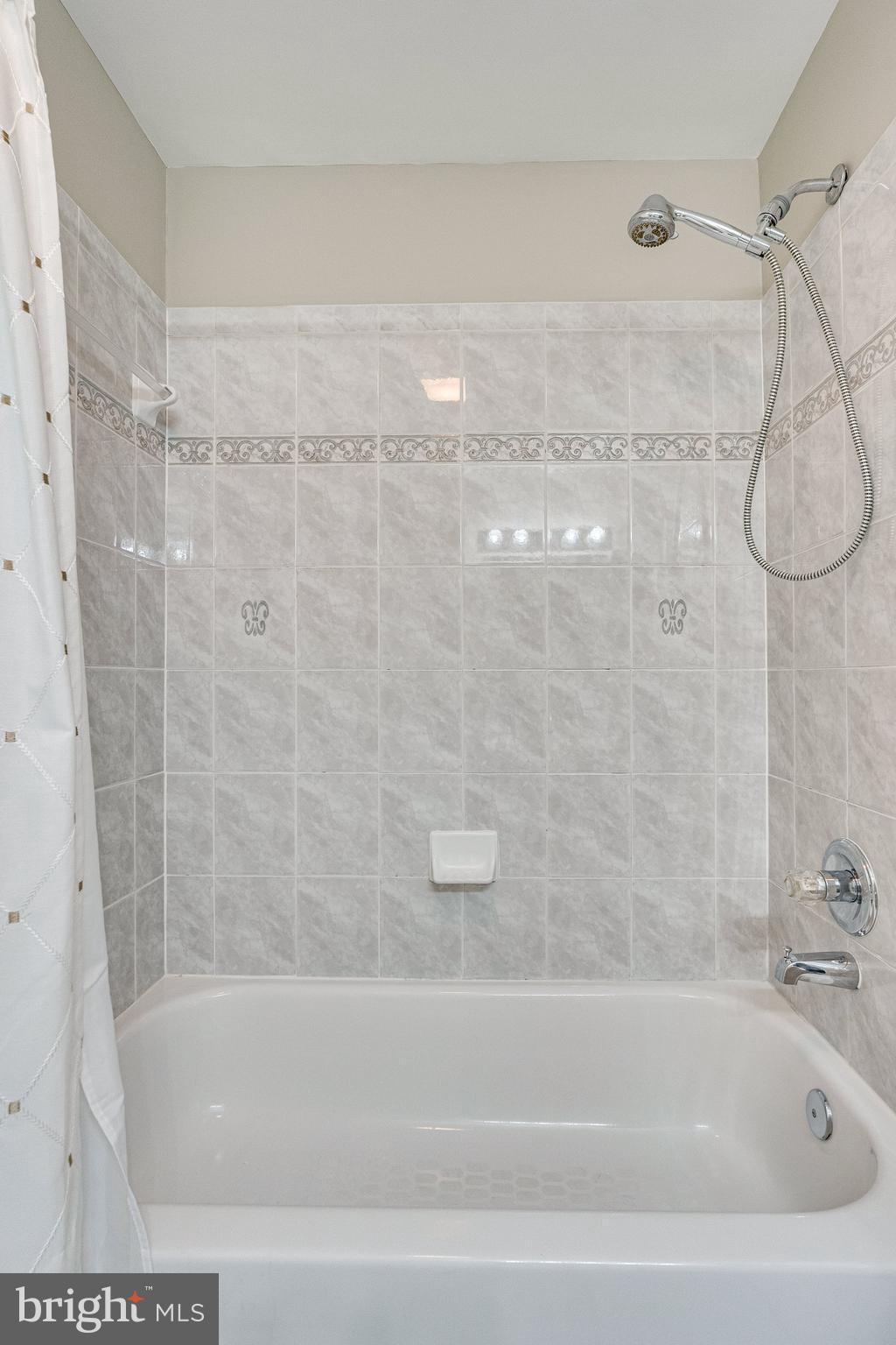 7802 Creekside View Lane Springfield, VA 22153 - Photo 77 of 107 a bathroom with a shower and a bath tub