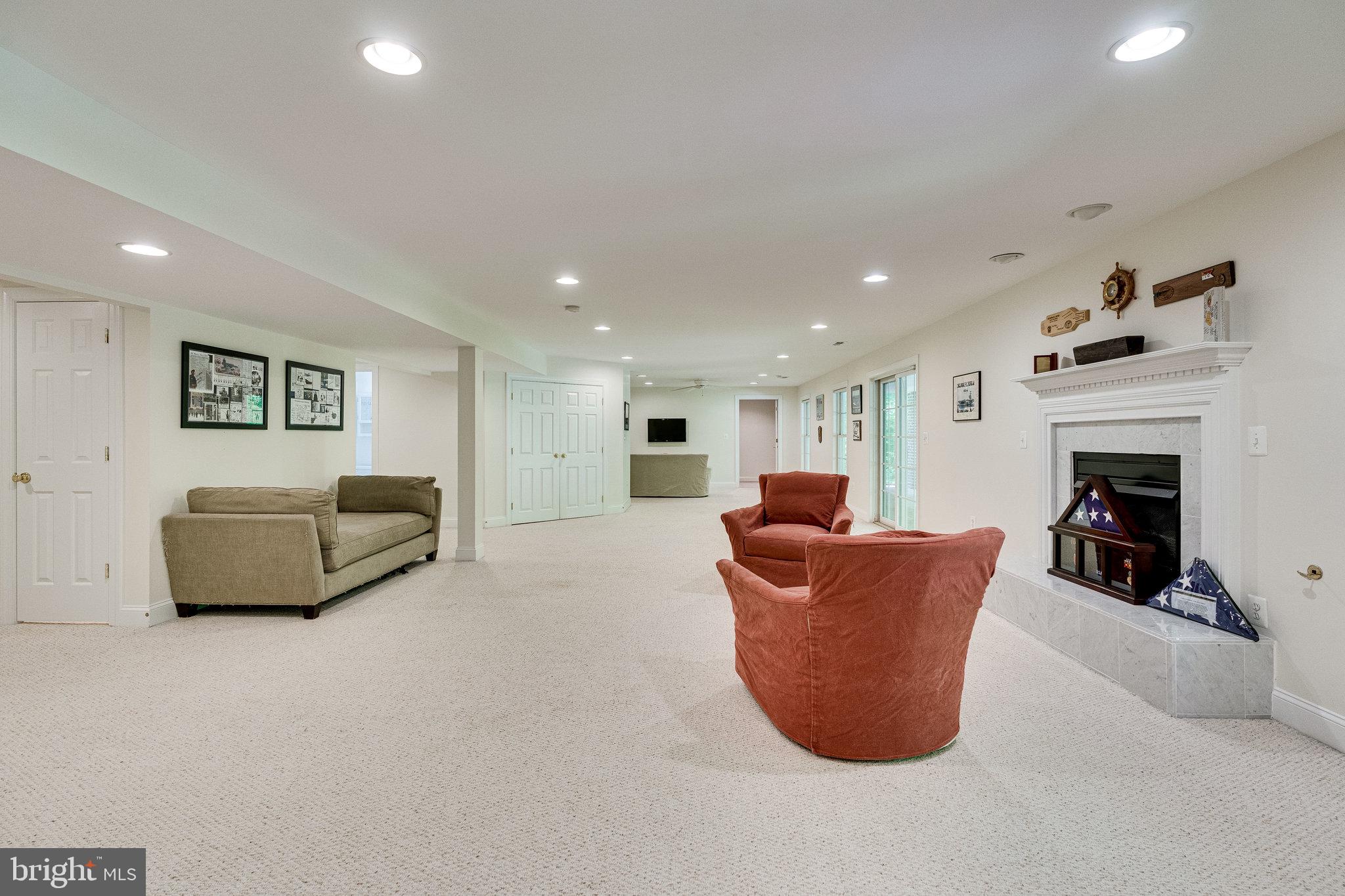 7802 Creekside View Lane Springfield, VA 22153 - Photo 83 of 107 a living room with furniture a fireplace and a flat screen tv