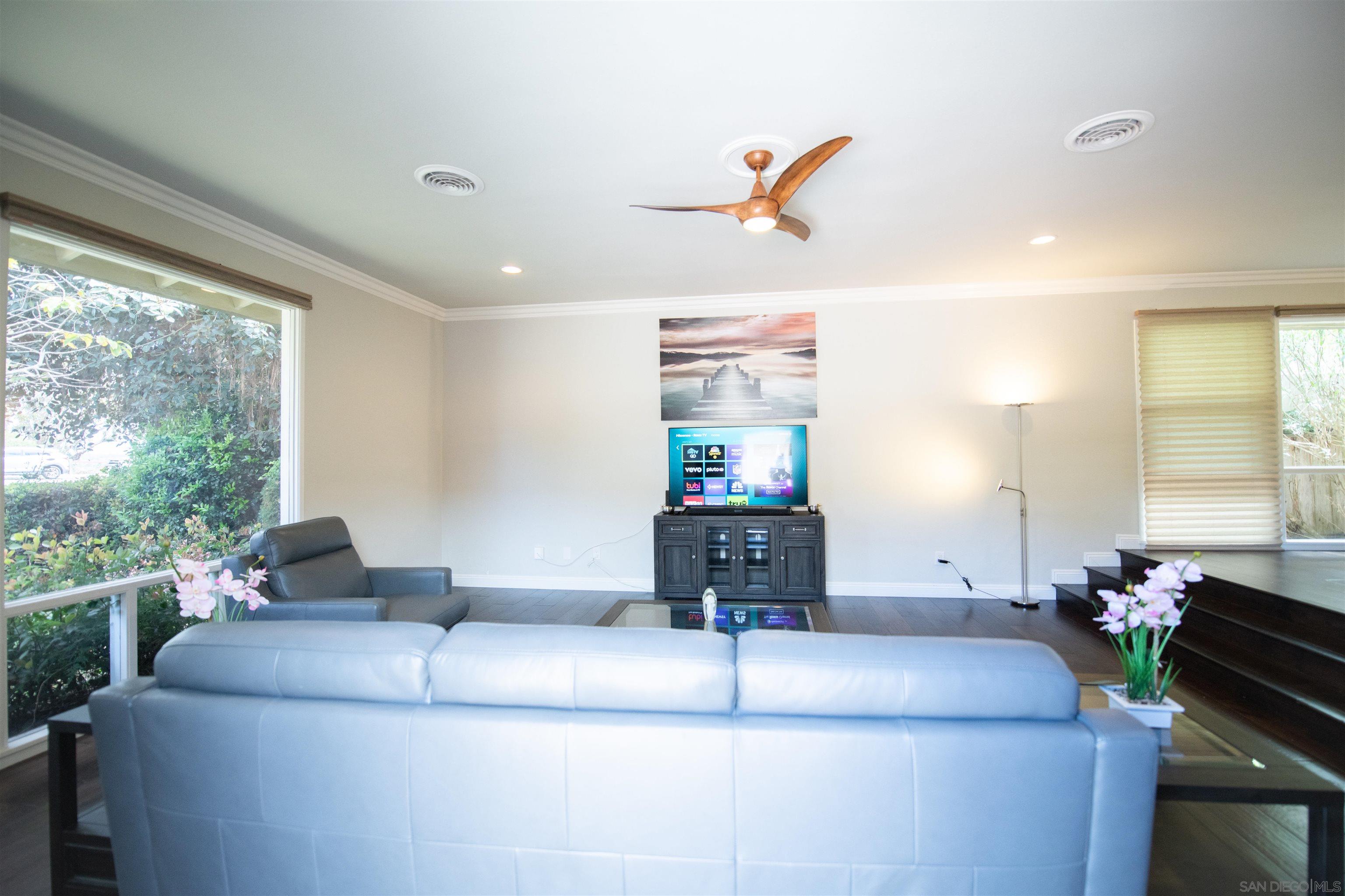 8874 La Jolla Scenic Drive North La Jolla, CA 92037 - Photo 1 of 73 a living room with furniture and a flat screen tv