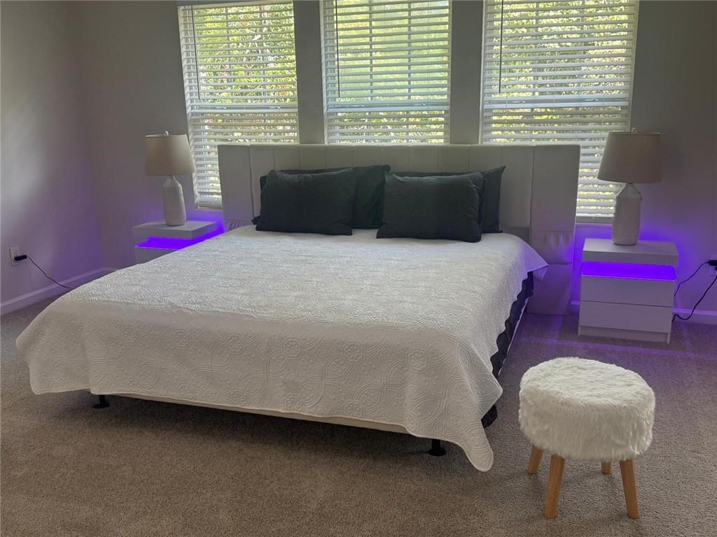 3926 Yosemite Park Lane Snellville, GA 30039 - Photo 3 of 10 a bedroom with a bed and a window