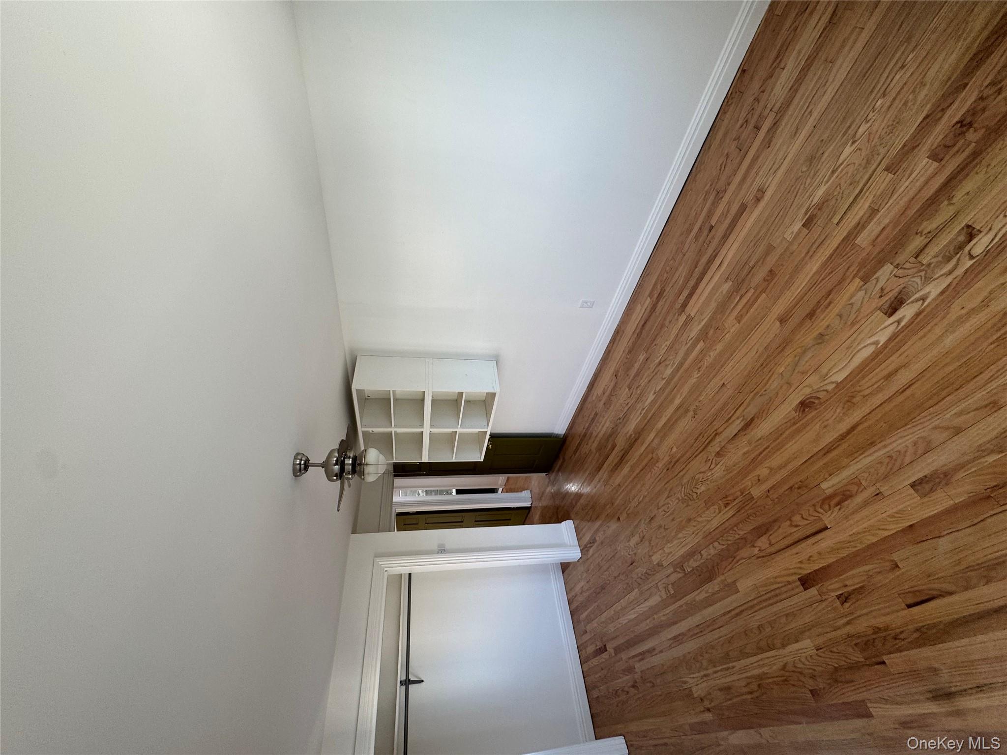 103-14 169th Street Queens, NY 11433 - Photo 14 of 18 Unfurnished bedroom with ceiling fan, wood finished floors, and a closet