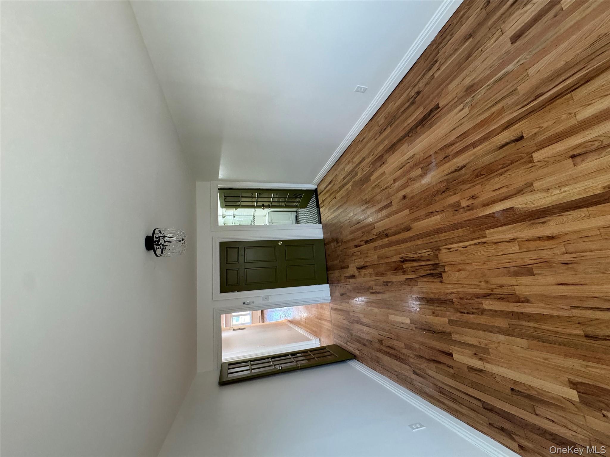 103-14 169th Street Queens, NY 11433 - Photo 16 of 18 Unfurnished living room with hardwood / wood-style flooring and baseboards