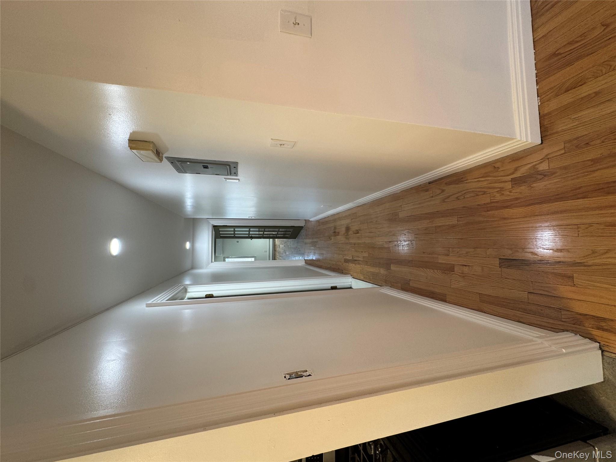 103-14 169th Street Queens, NY 11433 - Photo 8 of 18 Hall with hardwood / wood-style flooring, recessed lighting, and electric panel