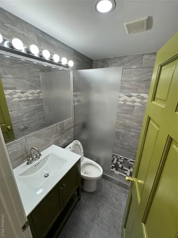 a bathroom with a sink mirror and toilet