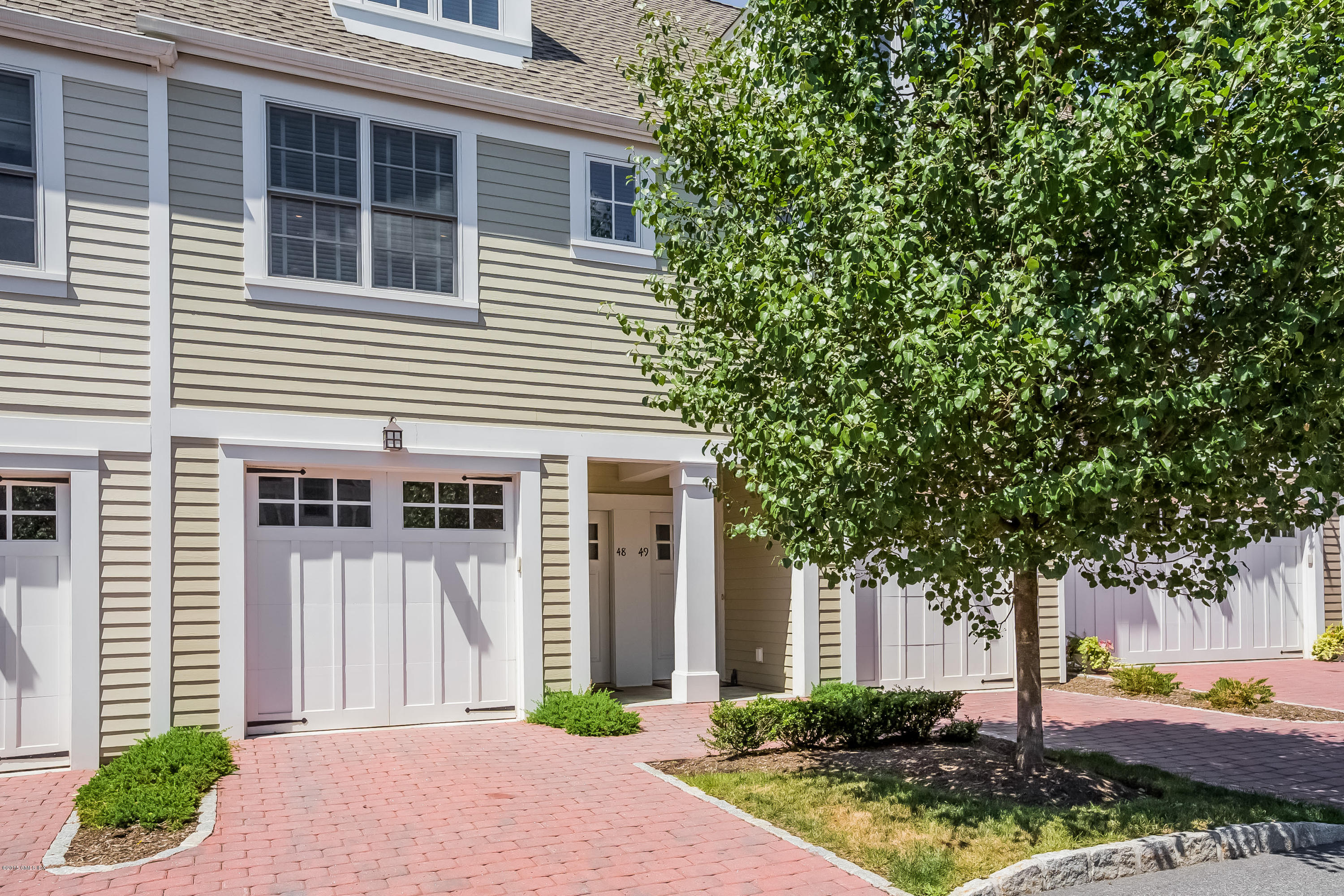 77 Havemeyer Lane, Unit 48 Stamford, CT 06902 - Photo 1 of 16 a front view of a house with garden