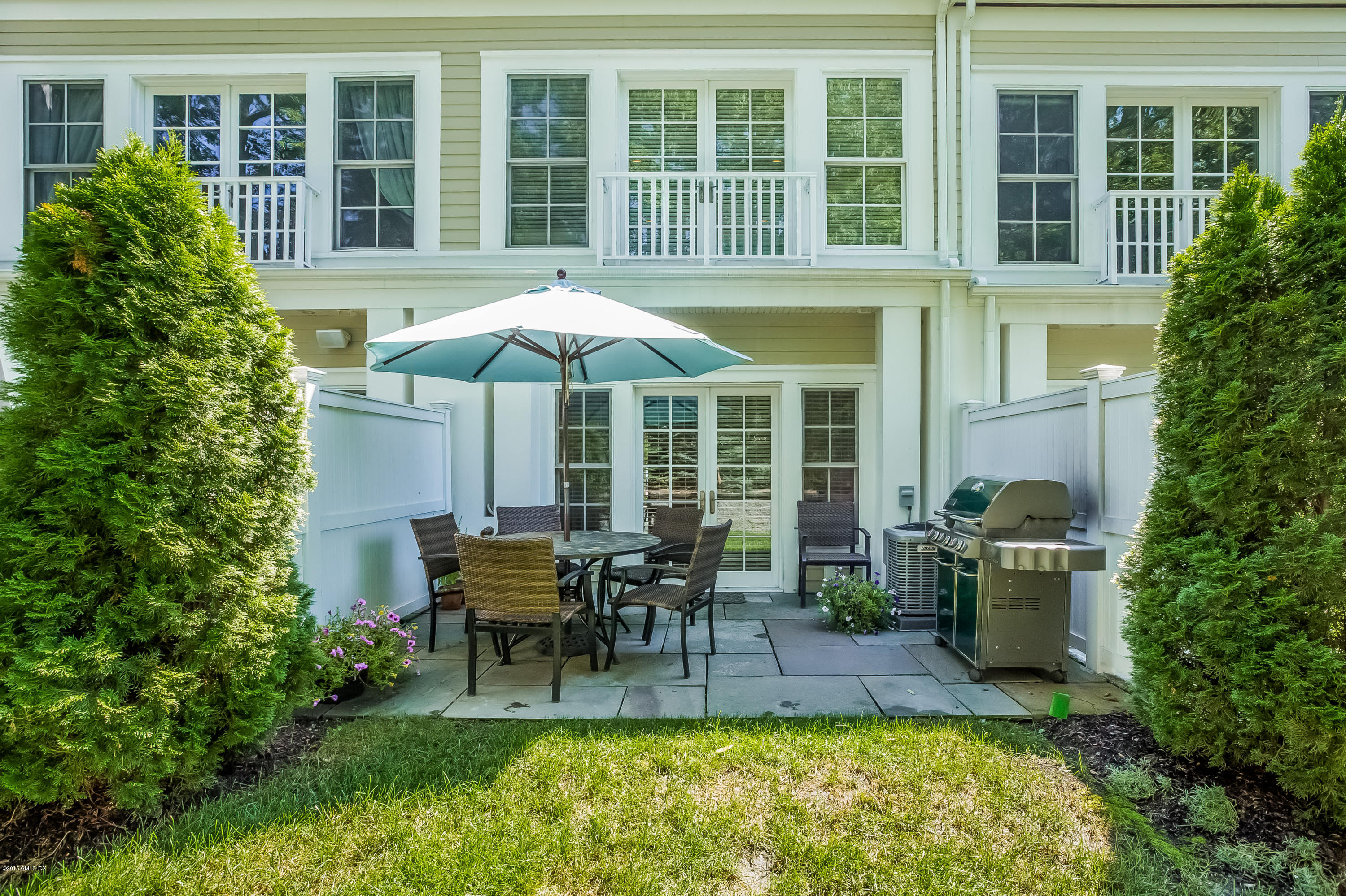 77 Havemeyer Lane, Unit 48 Stamford, CT 06902 - Photo 11 of 16 a view of a house with backyard sitting area and swimming pool