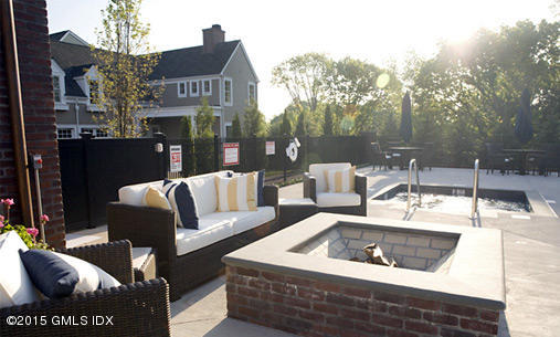77 Havemeyer Lane, Unit 48 Stamford, CT 06902 - Photo 16 of 16 a view of a patio with couches table and chairs and potted plants