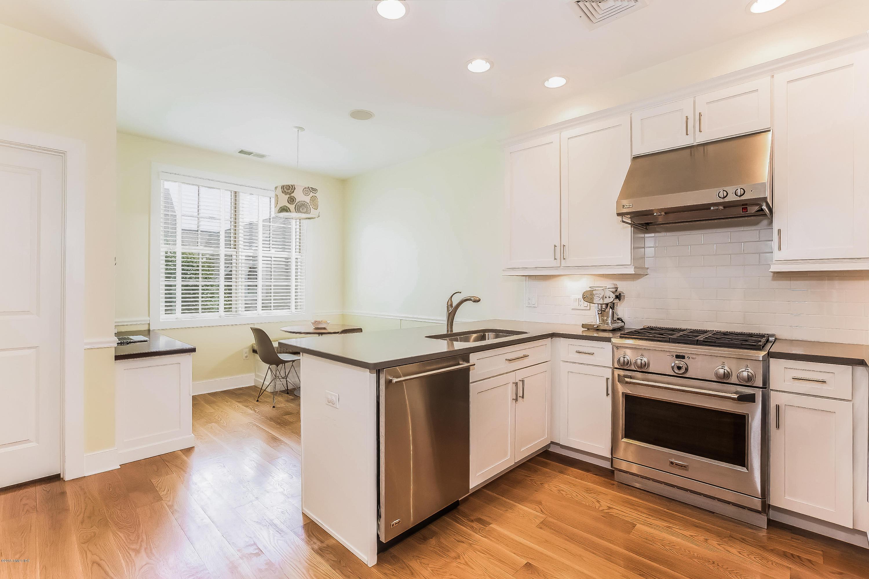 77 Havemeyer Lane, Unit 48 Stamford, CT 06902 - Photo 2 of 16 a kitchen with a stove a sink and a microwave