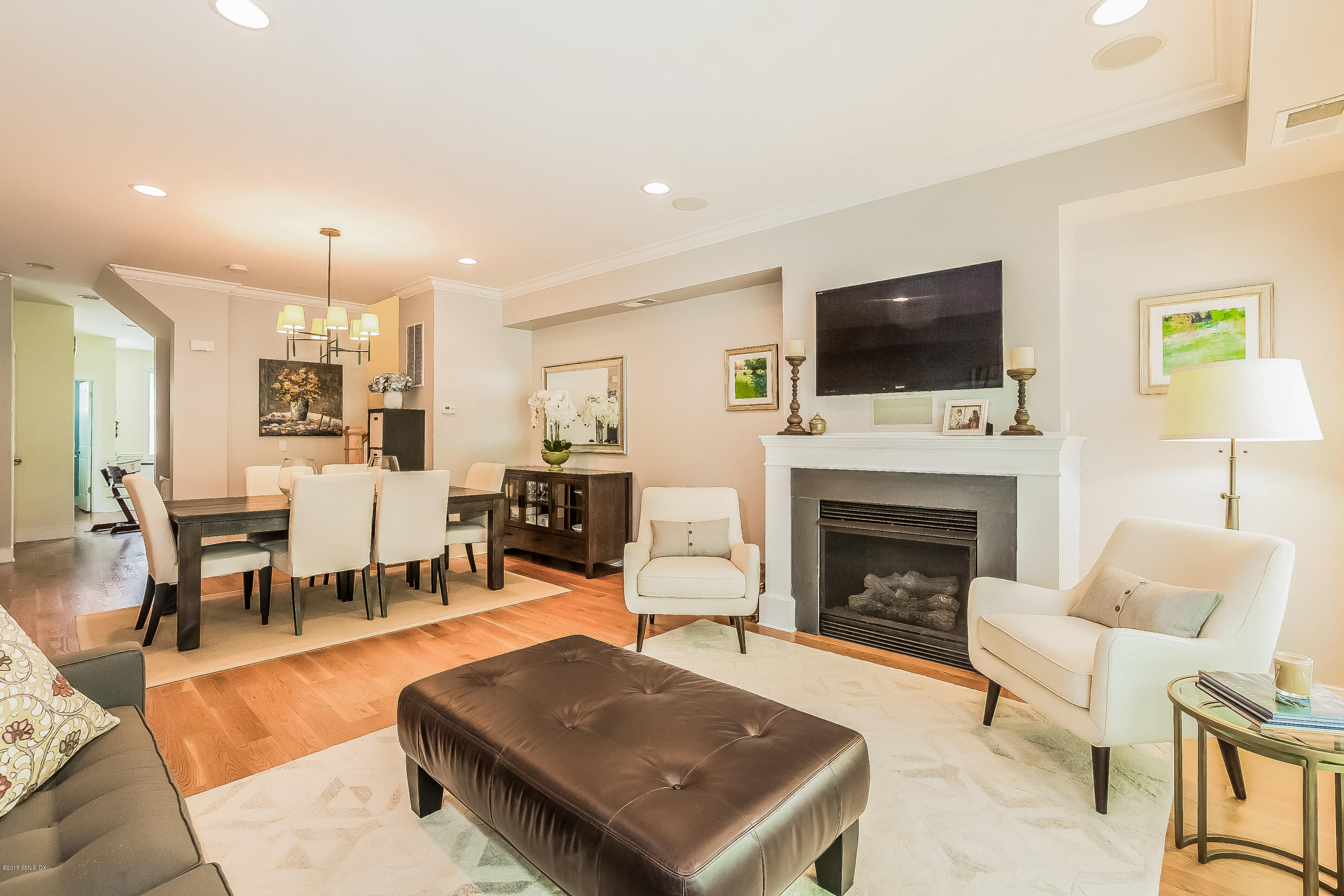 77 Havemeyer Lane, Unit 48 Stamford, CT 06902 - Photo 5 of 16 a living room with furniture a fireplace and a flat screen tv
