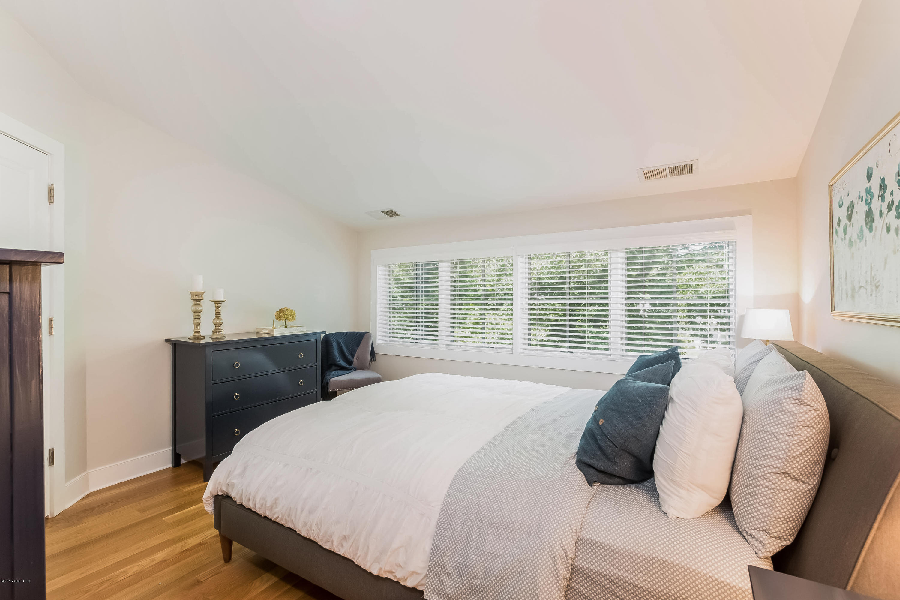 77 Havemeyer Lane, Unit 48 Stamford, CT 06902 - Photo 6 of 16 a bedroom with a bed and wooden floor