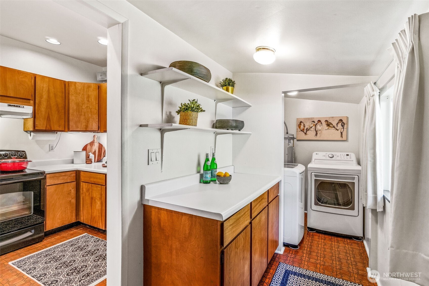 2358 Northwest 73rd Street Seattle, WA 98117 - Photo 11 of 18 a kitchen with a sink cabinets and stove top oven