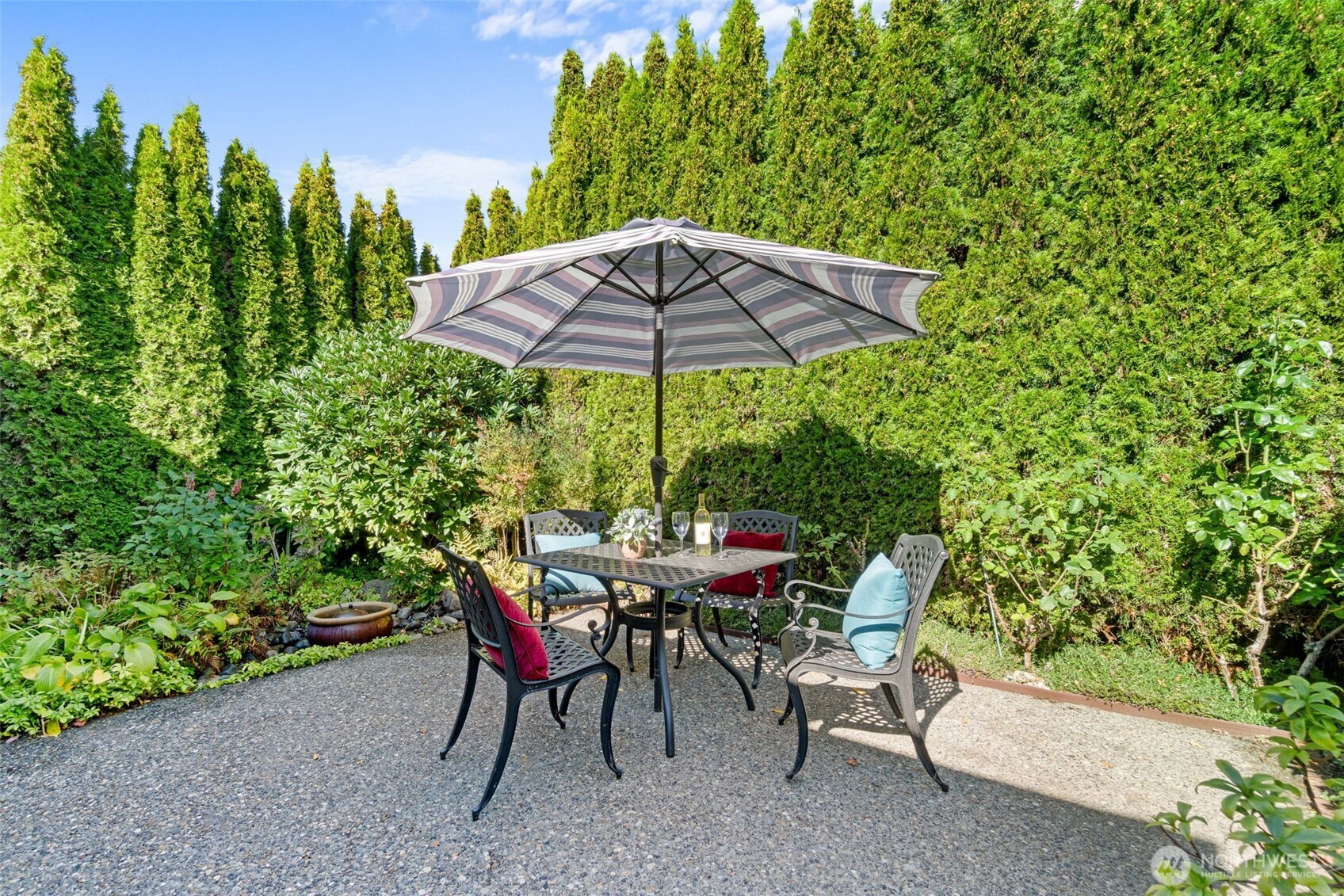 2358 Northwest 73rd Street Seattle, WA 98117 - Photo 15 of 18 a view of a backyard with table and chairs under an umbrella