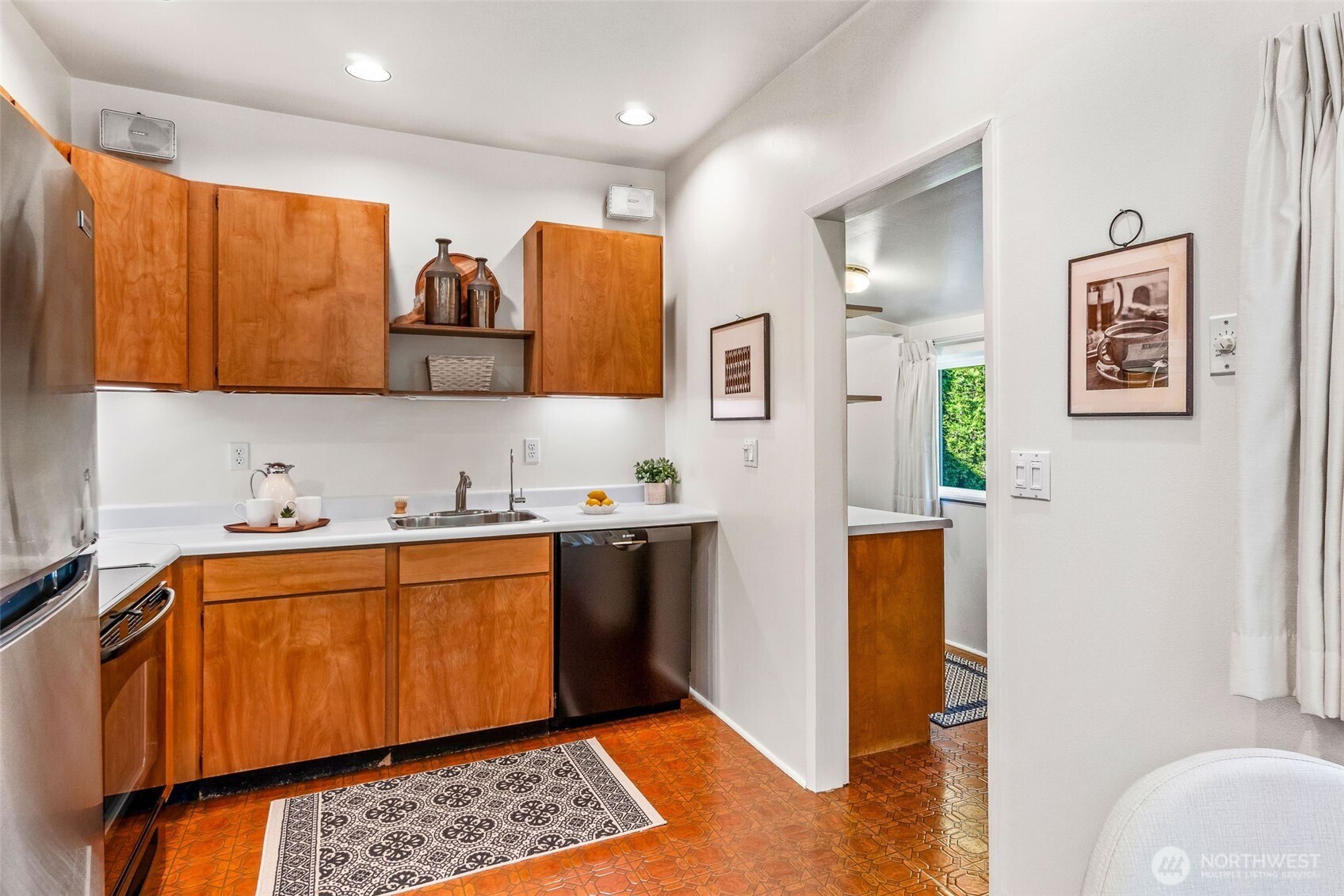2358 Northwest 73rd Street Seattle, WA 98117 - Photo 8 of 18 a kitchen with stainless steel appliances granite countertop a refrigerator and a stove top oven