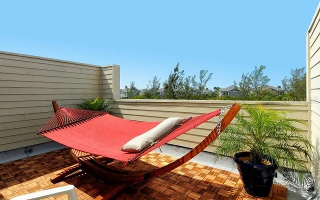a living room with furniture and floor to ceiling windows