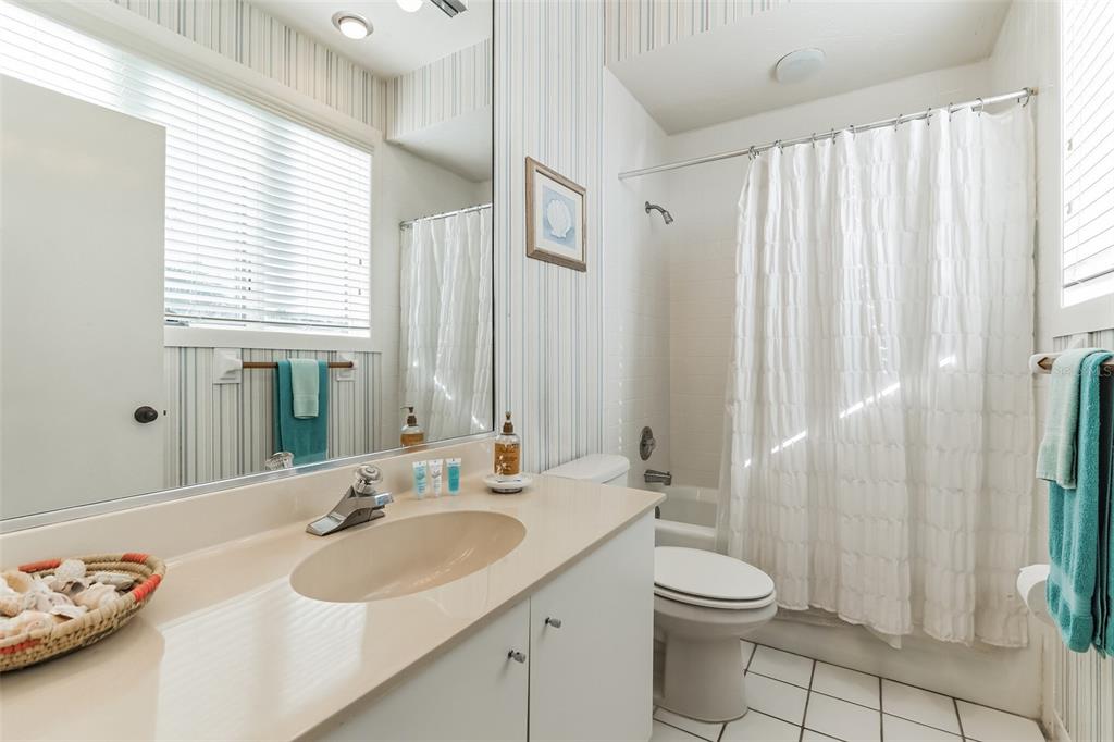 619 Cedars Court Longboat Key, FL 34228 - Photo 43 of 95 a bathroom with a sink a toilet and a large mirror