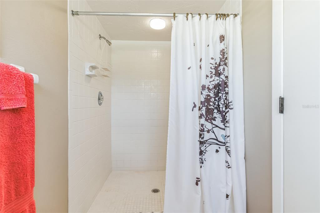 619 Cedars Court Longboat Key, FL 34228 - Photo 47 of 95 a bathroom with a shower and a curtain