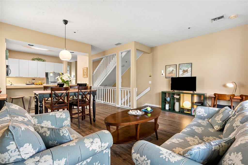 619 Cedars Court Longboat Key, FL 34228 - Photo 58 of 95 a living room with furniture kitchen view and a flat screen tv