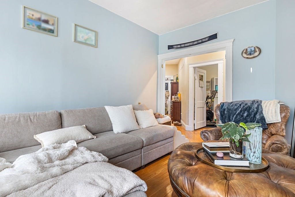 21 Sutherland Road, Unit 6 Boston, MA 02135 - Photo 13 of 20 a living room with furniture and a wooden floor