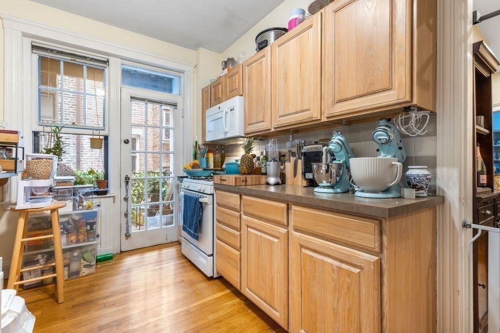21 Sutherland Road, Unit 6 Boston, MA 02135 - Photo 18 of 20 a kitchen with stainless steel appliances granite countertop a stove and cabinets