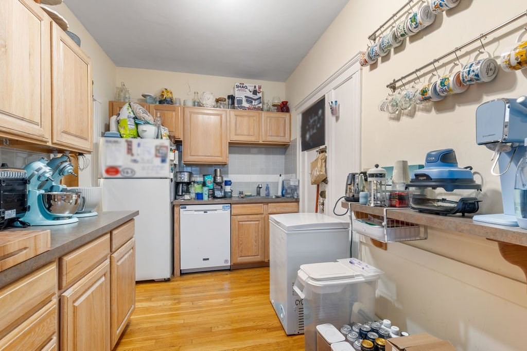 21 Sutherland Road, Unit 6 Boston, MA 02135 - Photo 19 of 20 a kitchen with a sink appliances and cabinets