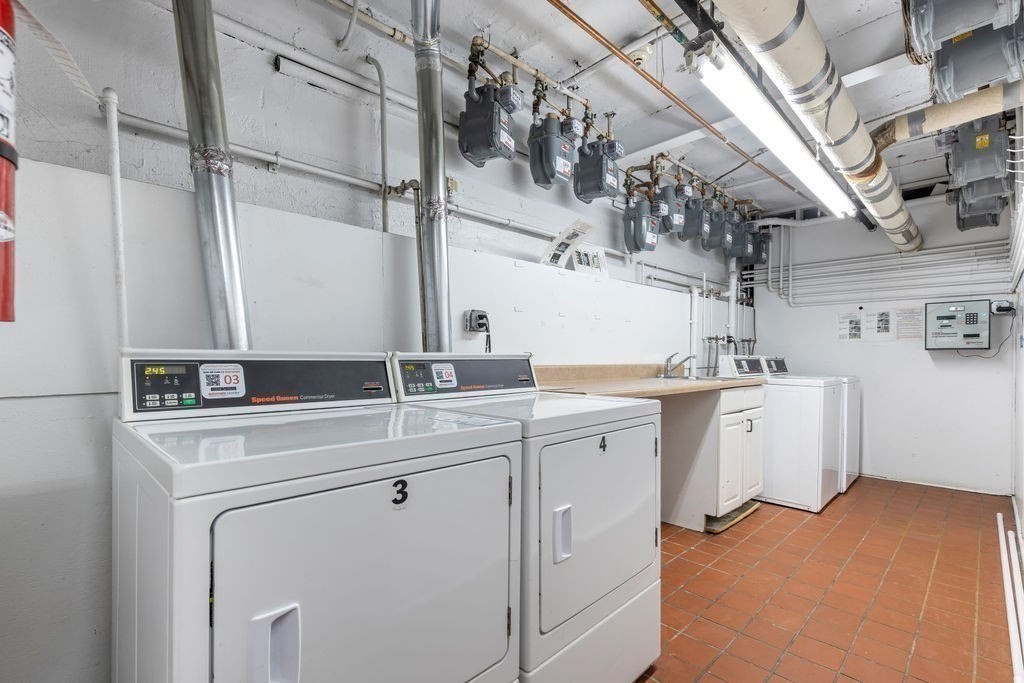 21 Sutherland Road, Unit 6 Boston, MA 02135 - Photo 20 of 20 a utility room with cabinets dryer and washer