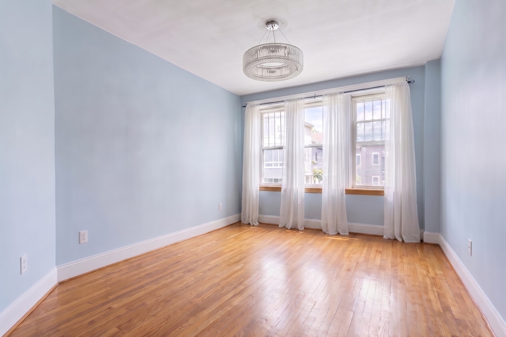 21 Sutherland Road, Unit 6 Boston, MA 02135 - Photo 2 of 20 an empty room with wooden floor and windows