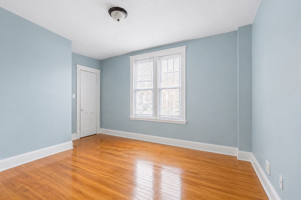 21 Sutherland Road, Unit 6 Boston, MA 02135 - Photo 6 of 20 a view of an empty room with wooden floor and a window