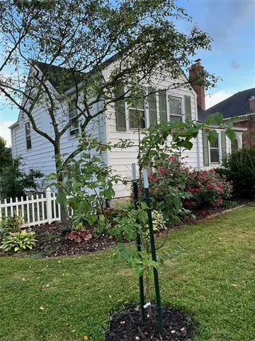 a front view of a house with a yard and porch