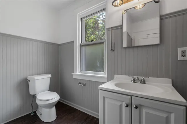 a bathroom with a toilet sink and mirror