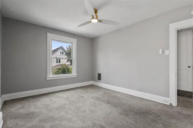 an empty room with windows and closet