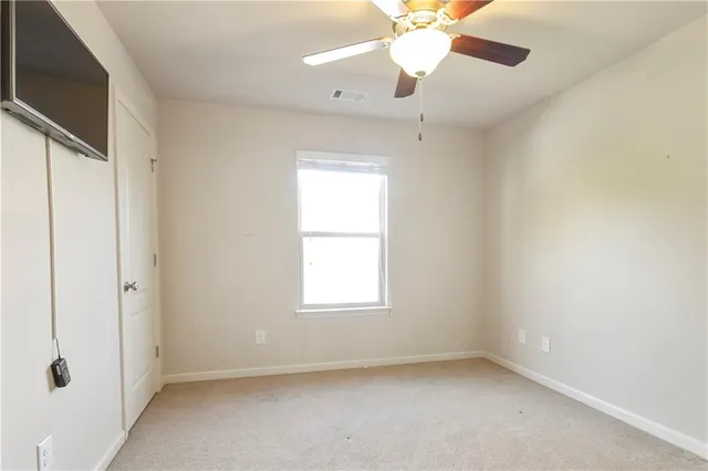 walk in closet with a window and a kitchen