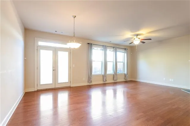 a view of a room with wooden floor and windows