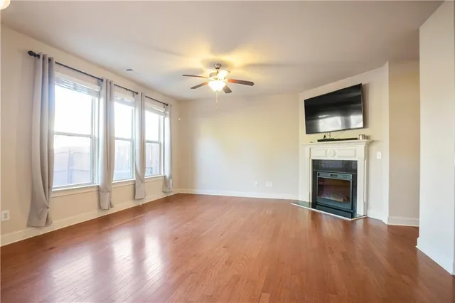 wooden floor fireplace and natural light in room