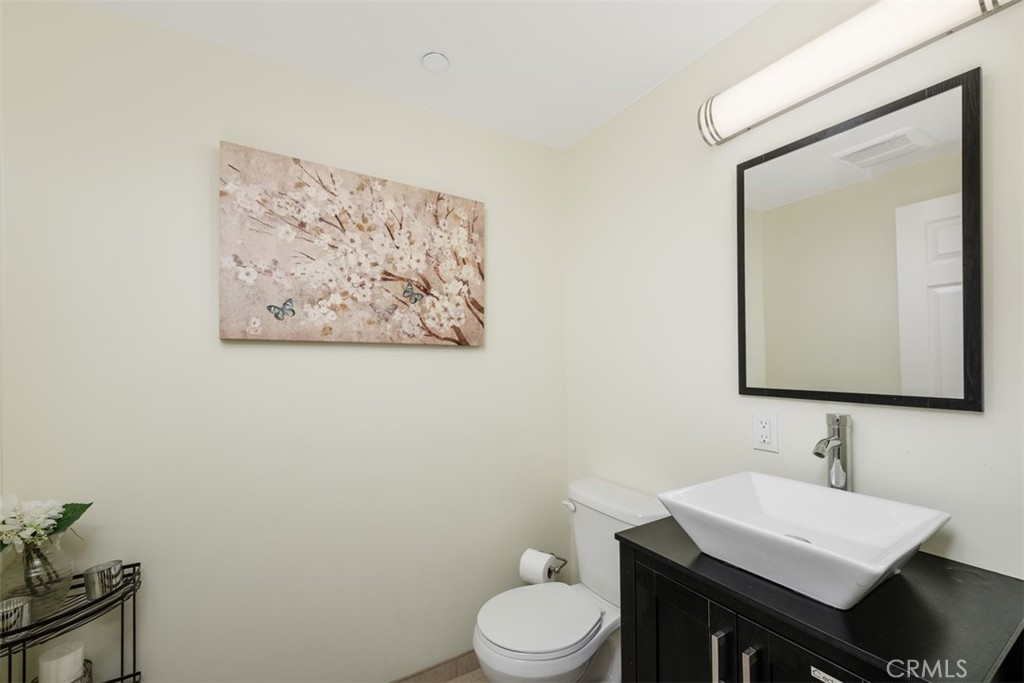900 Dwight Avenue, Unit 108 Compton, CA 90220 - Photo 11 of 49 a bathroom with a toilet sink and mirror
