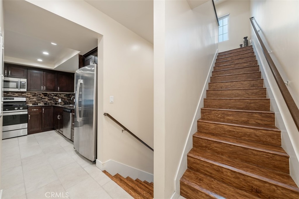 900 Dwight Avenue, Unit 108 Compton, CA 90220 - Photo 12 of 49 a kitchen with a refrigerator and a stove top oven