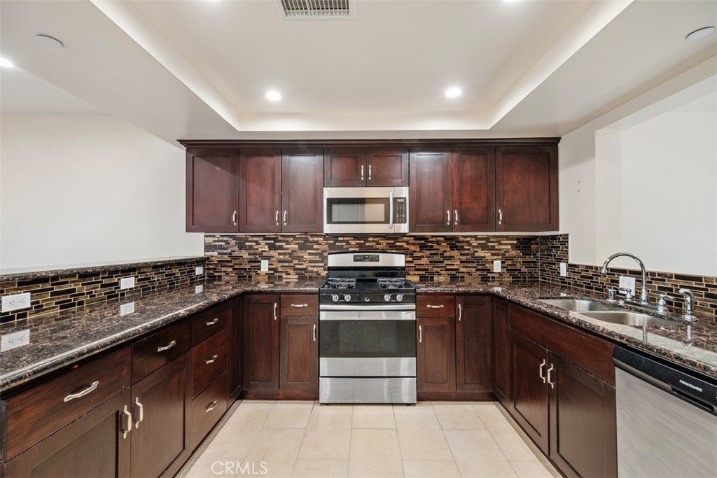 900 Dwight Avenue, Unit 108 Compton, CA 90220 - Photo 14 of 49 a kitchen with a sink and a stove top oven