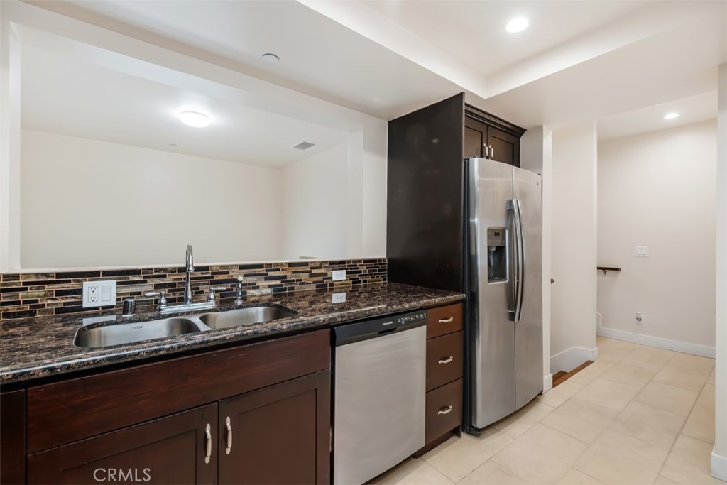 900 Dwight Avenue, Unit 108 Compton, CA 90220 - Photo 23 of 49 a kitchen with stainless steel appliances granite countertop a refrigerator and a sink