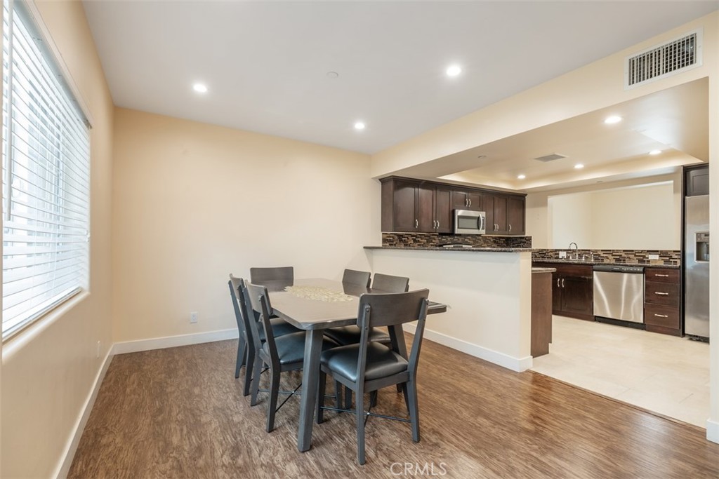 900 Dwight Avenue, Unit 108 Compton, CA 90220 - Photo 27 of 49 a view of a dining room with furniture and wooden floor