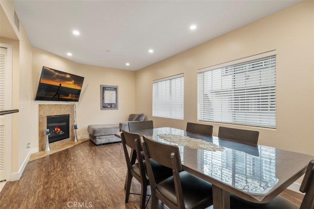 900 Dwight Avenue, Unit 108 Compton, CA 90220 - Photo 29 of 49 a living room with furniture a fireplace and a flat screen tv