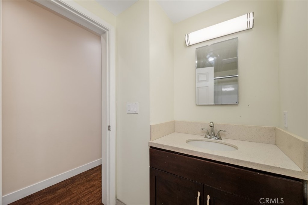 900 Dwight Avenue, Unit 108 Compton, CA 90220 - Photo 31 of 49 a bathroom with a sink and a mirror