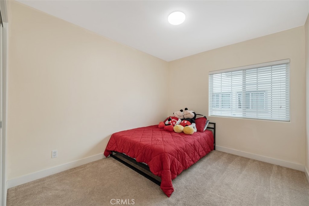 900 Dwight Avenue, Unit 108 Compton, CA 90220 - Photo 33 of 49 a bedroom with a bed and window