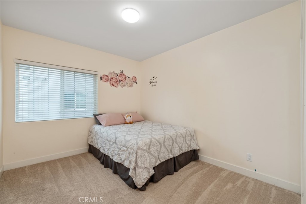 900 Dwight Avenue, Unit 108 Compton, CA 90220 - Photo 34 of 49 a bedroom with a bed and a window