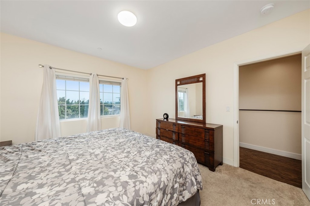 900 Dwight Avenue, Unit 108 Compton, CA 90220 - Photo 36 of 49 a bedroom with a bed and a dresser next to a window
